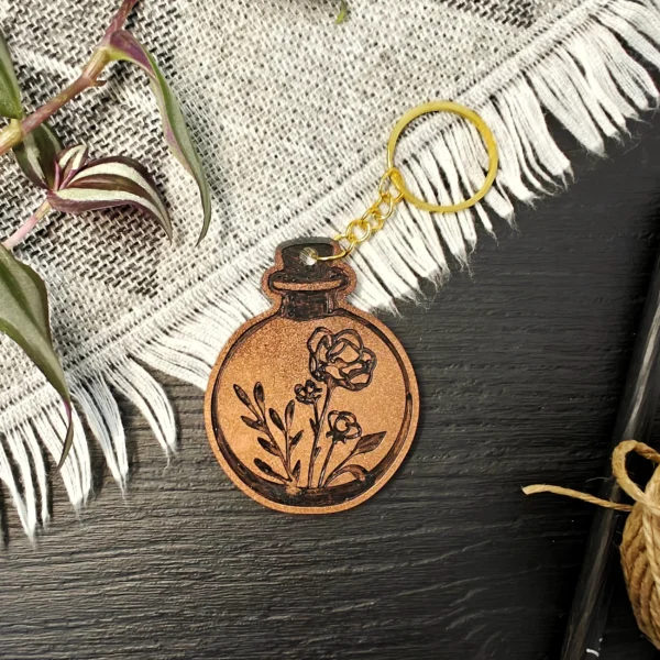 processed_9d6848a2827e4ab9918802e2ecce5b10.webp Flower Potion Keychains