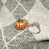 processed_ce7b941f8e7841ac9e56edef615855fb.webp Creepy Golden Pumpkins Keychains